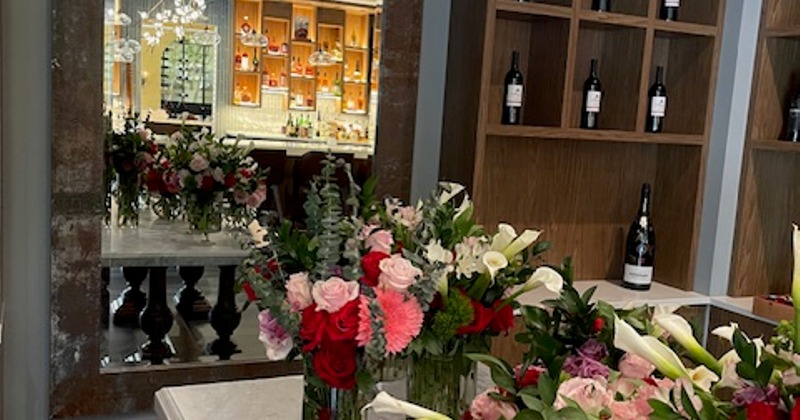 A table in bar area decorated with floral arrangements