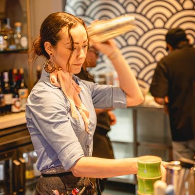 A person preparing a cocktail.