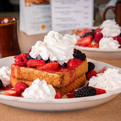 French Toast topped with whipped cream and fresh berries.