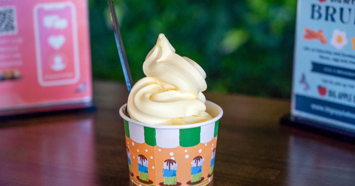 Vanilla soft serve ice cream in a colorful paper cup