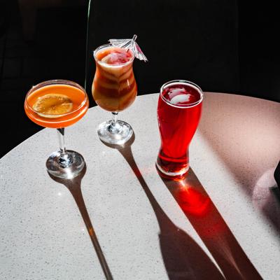 Three different cocktails served together on the table.