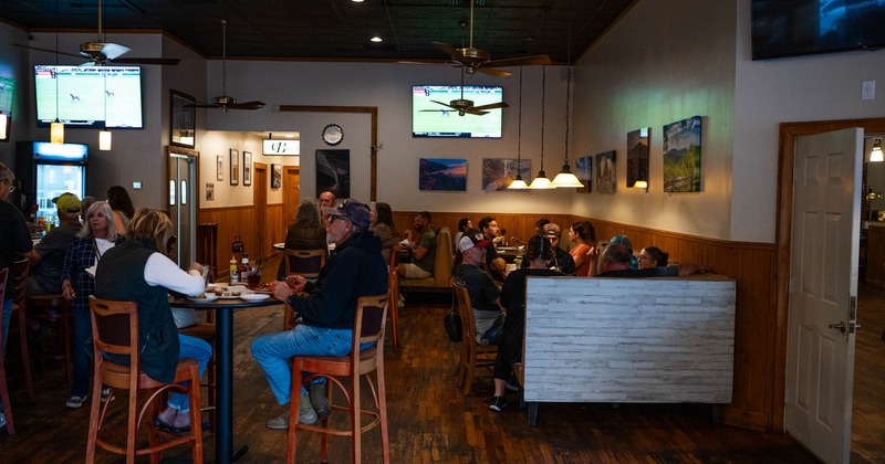 People enjoying food and drinks in a busy restaurant