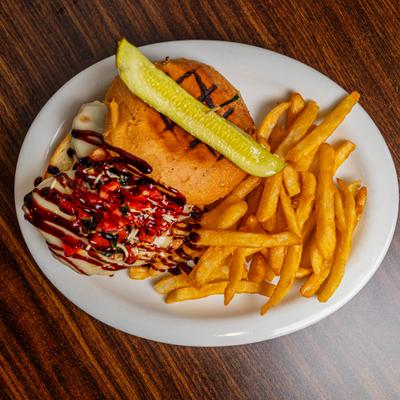 Bruschetta chicken sandwich with fries on the side.