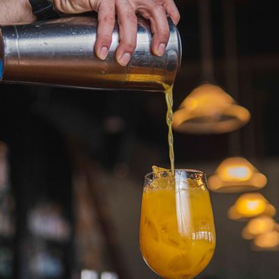A drink being poured in a glass