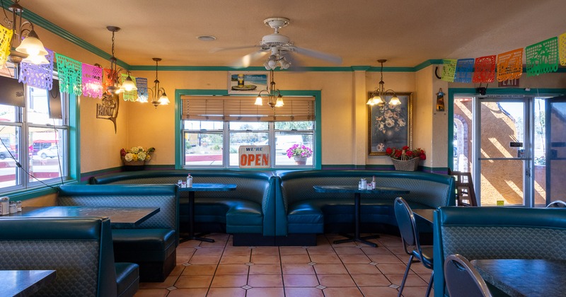 Interior of cozy dining area decorated with hanging paper ornaments