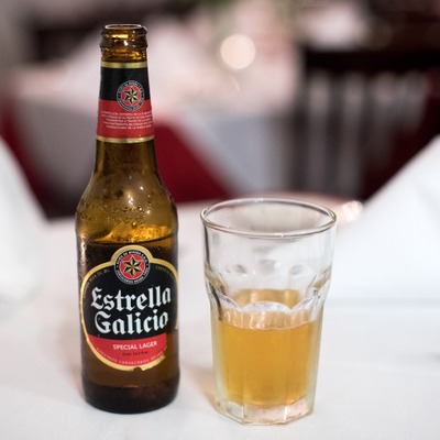 Estrella Galicia beer bottle and a glass of beer