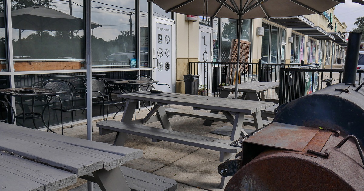Outdoor seating area with wooden tables and benches