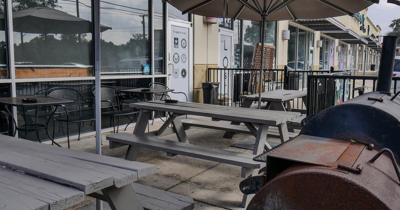 Outdoor seating area with wooden tables and benches