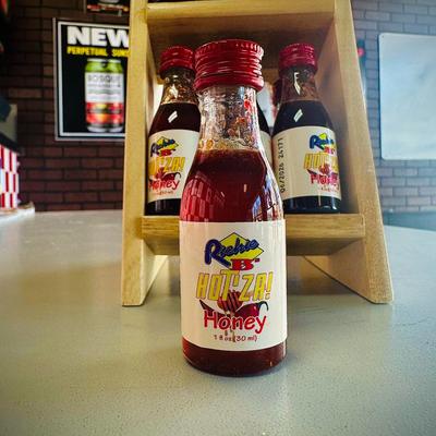 Interior, bottles of hot sauces on a table.