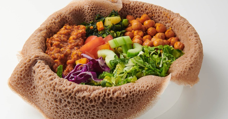 Injerra bowl with various toppings