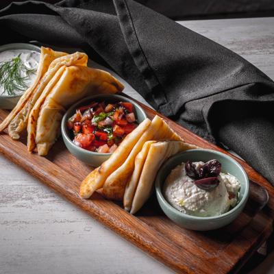 Mediterranean dips served with pita wedges.