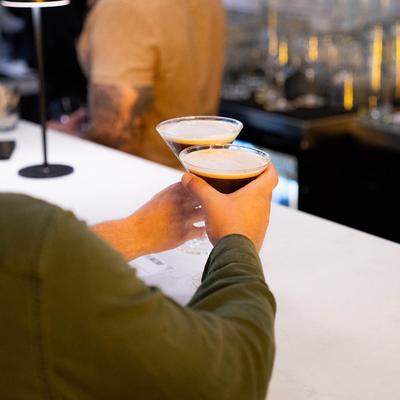 A person holding drinks.