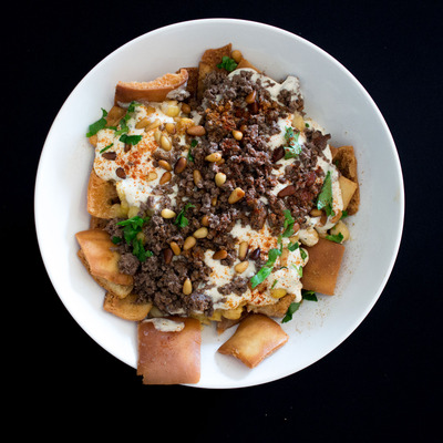 Nachos with meat, cream and nuts with spices