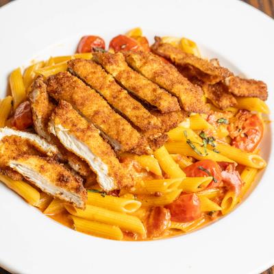 Fried chicken with penne pasta, tomatoes, basil, and tomato cream sauce.