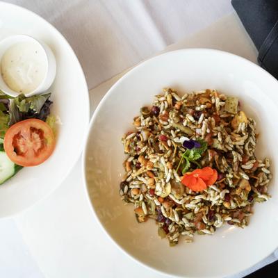Rice dish served with side salad and dressing.