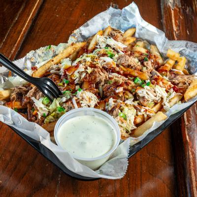Loaded BBQ Fries served with a dopping sauce on the side.