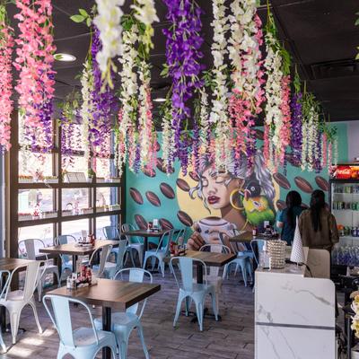 Interior, tables, chairs, flower arrangements.