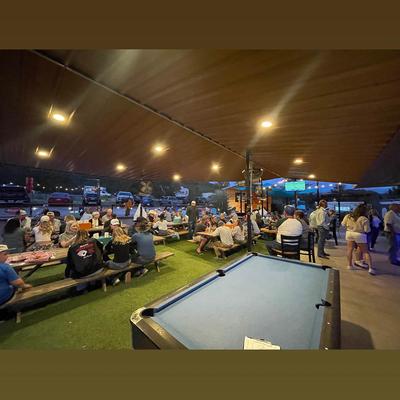 Covered outdoor seating area with a pool table.
