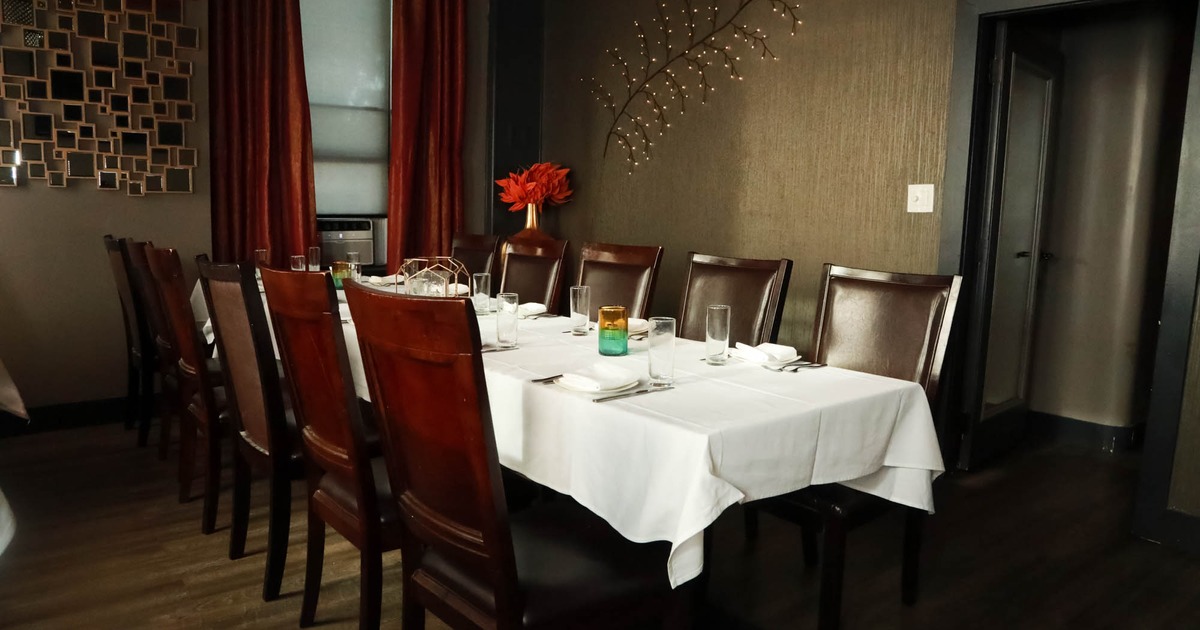 Interior, fully set dinner tables