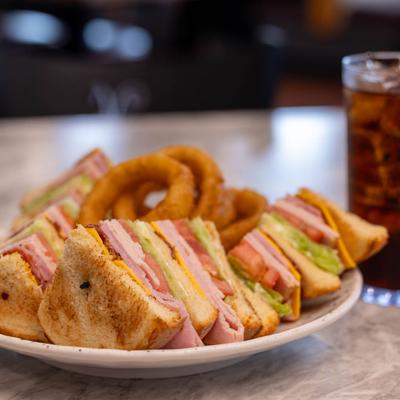 Classic Club served with onion rings and coke.