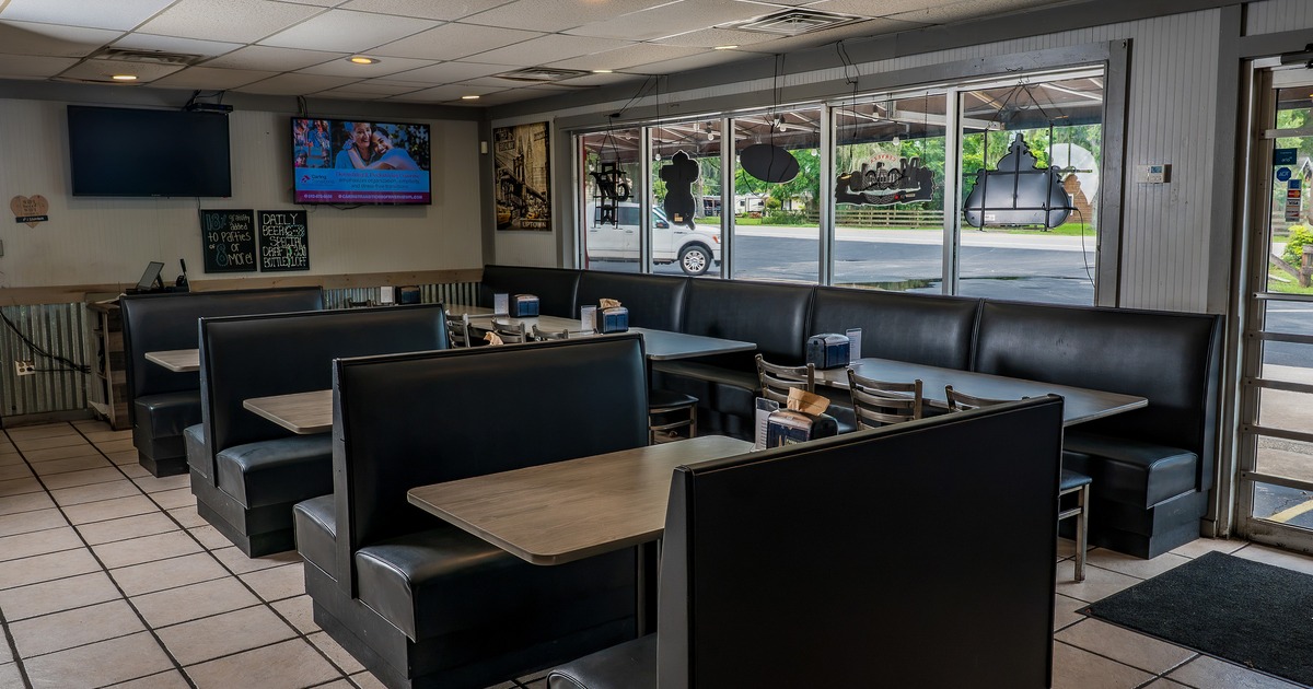 Interior of cozy dining area with upholstered booths