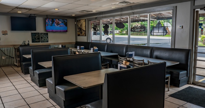 Interior of cozy dining area with upholstered booths