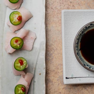 Sliced raw yellowtail and jalapeño in ponzu sauce.