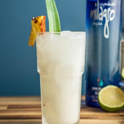 Pineapple Coconut Margarita garnished with a pineapple wedge and a green leaf.