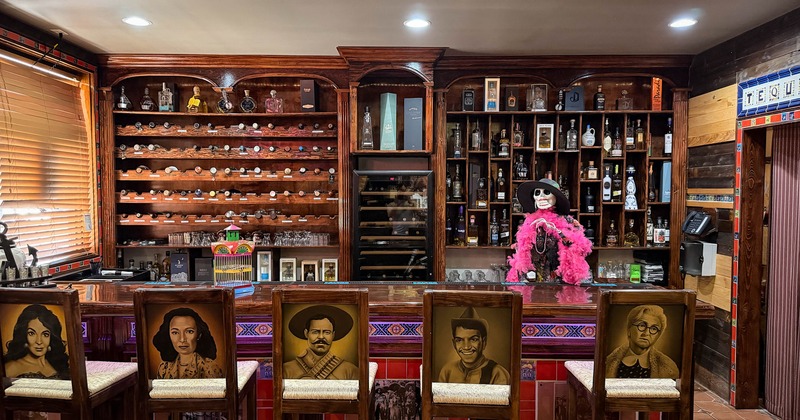 Interior, bar area with portraits on chairs