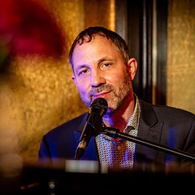 Tommy Douros singing and playing piano.