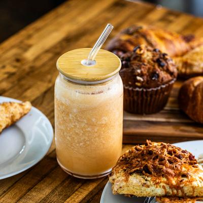 Sunshine Smoothie served in a jar, surrounded by assorted pastries.