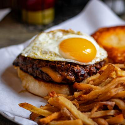 Bacon Jam Burger with fried egg and breakfast potatoes.