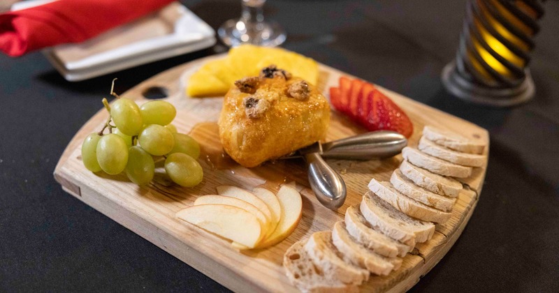 Brie cheese board with local fruit and crostini