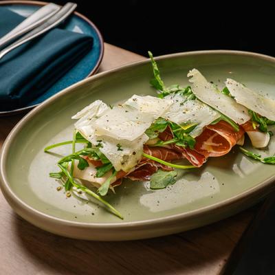 Prosciutto and arugula salad topped with shaved parmesan cheese.