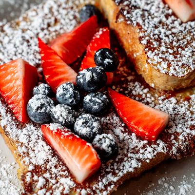 Texas French Toast, topped with berries and powdered sugar.