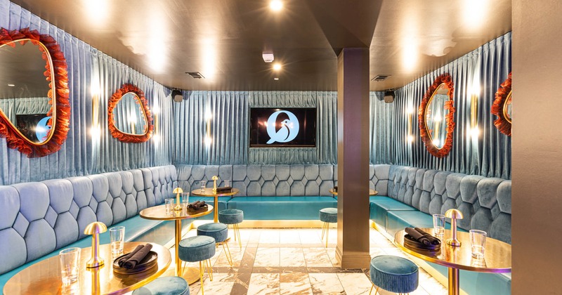 Interior, upholstered benches and walls, decorative mirrors, tables, chairs, glasses, lighting