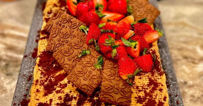 Cake with Argentinian cookies and fresh strawberries on top