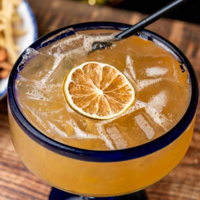 Margarita cocktail with a dehydrated citrus wheel.