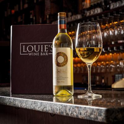 White wine bottle paired with a filled glass.