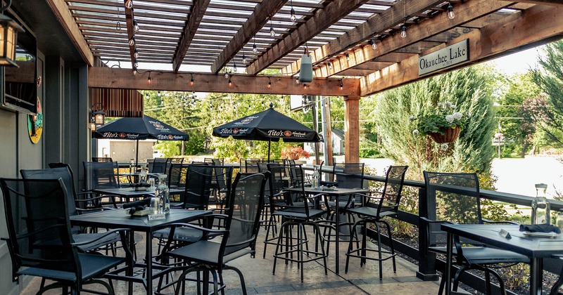 Patio tables and seats with parasols