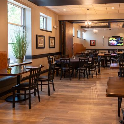 Dining area, banquette seating, tables, chairs, wall-mounted TV.