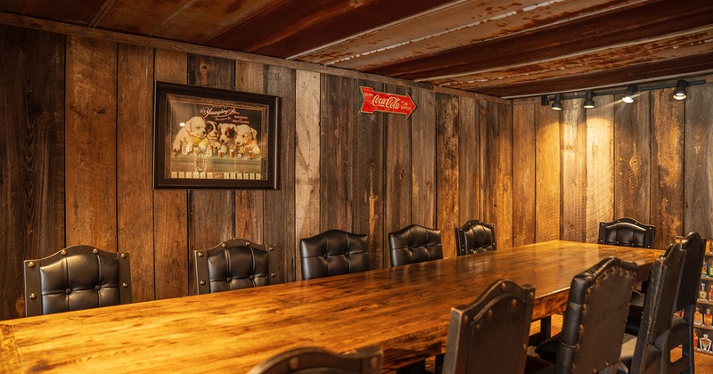 Private parties area with a vast wooden table and upholstered chairs