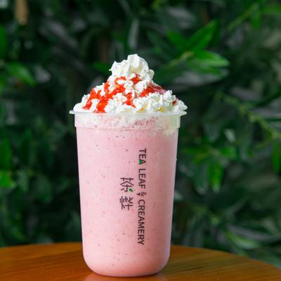 Strawberry Smoothie Tea topped with whipped cream and strawberry syrup.