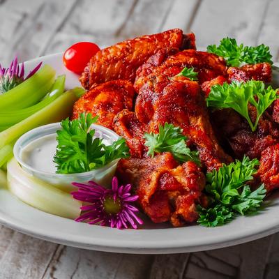 Buffalo wings with celery sticks and ranch dip.