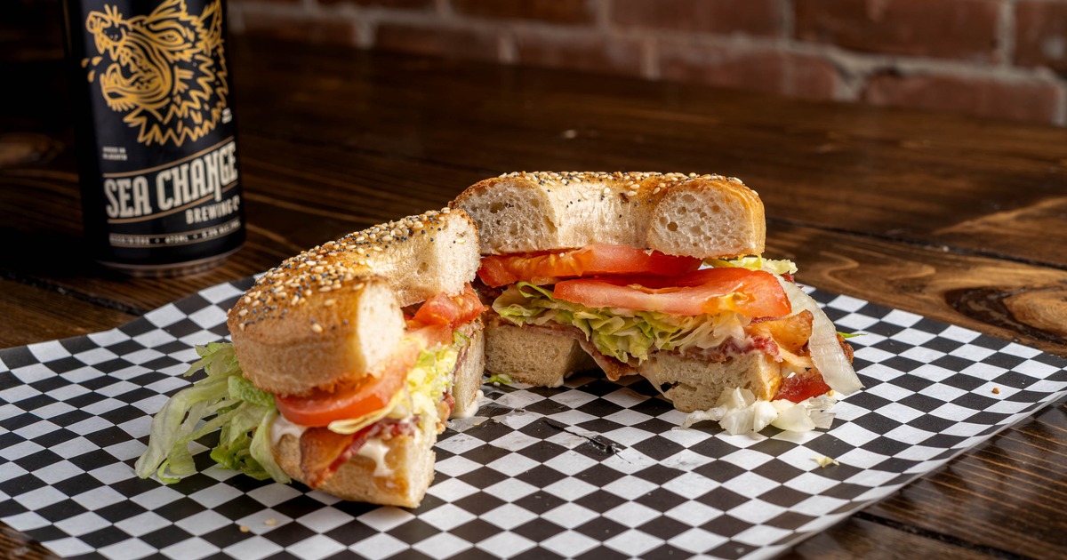 Toasted bagel with butter, smoky bacon, lettuce, tomato, and mayo