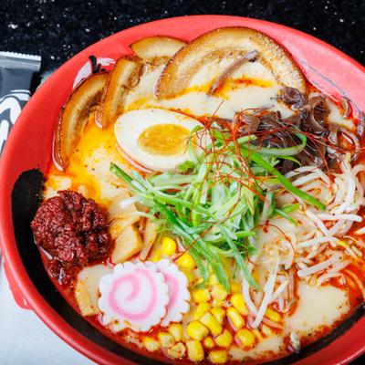 Akita volcano ramen pork belly, soft-boiled egg, sweet corn and fish cake.