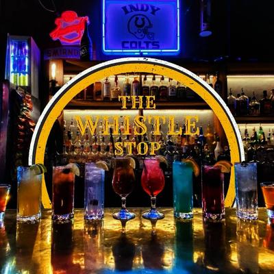 Assorted cocktail drinks aligned on the bar counter