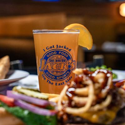 Pint of beer, garnished with a citrus slice.