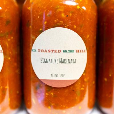 STL Toasted on the Hill, signature marinara in jars, close up.