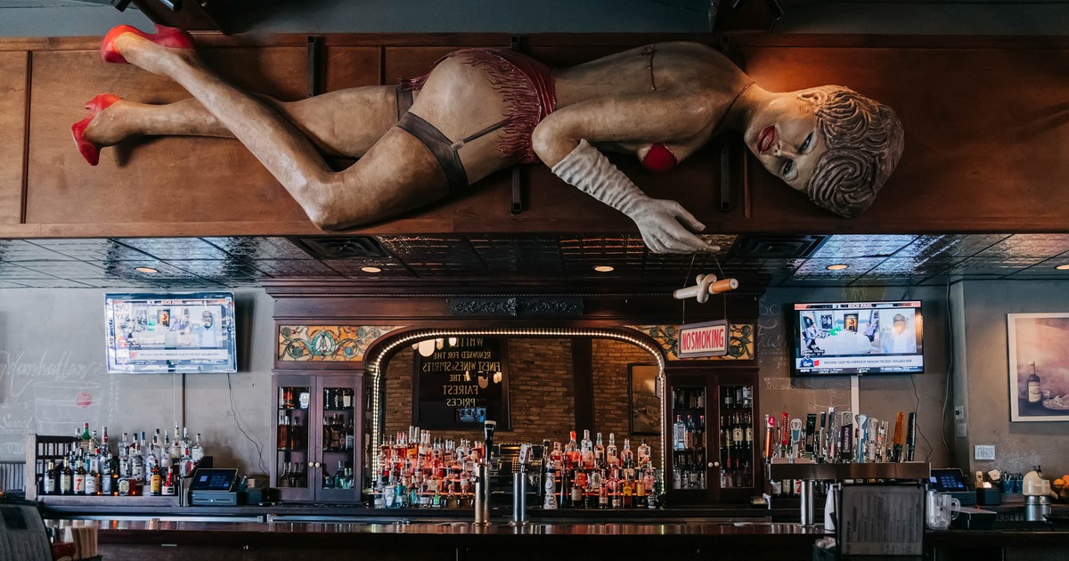 Interior, bar area, wooded dancer above the counter